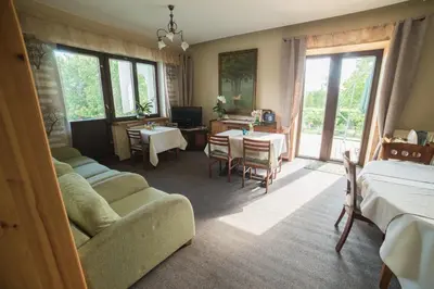 a bedroom with a bed and a couch and a table at Nemunas Tour Residence in Kaunas