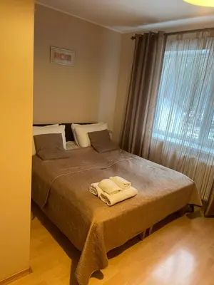 a bedroom with a bed with two towels on it at Hotel Jerevan in Druskininkai