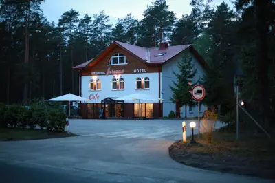 a large white building with a sign in front of it at Hotel Jerevan in Druskininkai