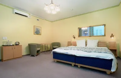 a bedroom with a bed and a table and chairs at Angel Town Hall Apartments in Vilnius