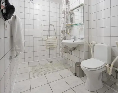 a white bathroom with a toilet and a sink at Angel Town Hall Apartments in Vilnius