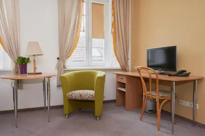 a room with a desk and a chair and a television at Angel Town Hall Apartments in Vilnius