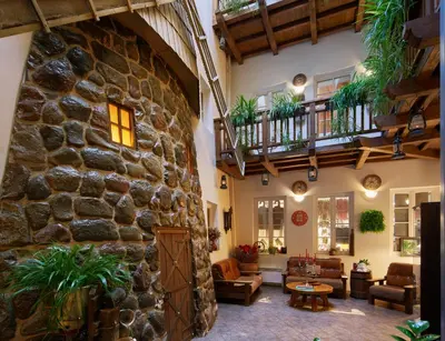 a living room with a large stone wall at Angel Town Hall Apartments in Vilnius