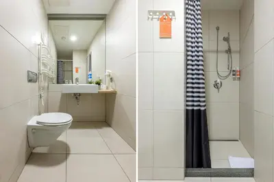 a bathroom with a toilet and a shower at Urbihop Hotel in Vilnius