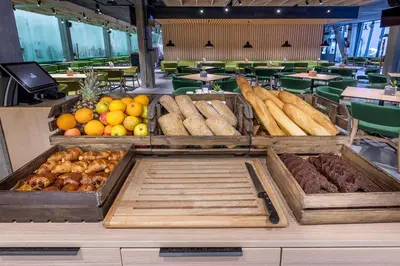 a buffet with different types of bread and fruits and vegetables at Urbihop Hotel in Vilnius
