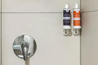 a close up of a bathroom door with a faucet at Urbihop Hotel in Vilnius