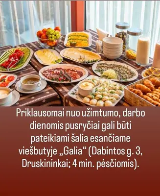 a table with a bunch of food on it at Hotel Medūna in Druskininkai