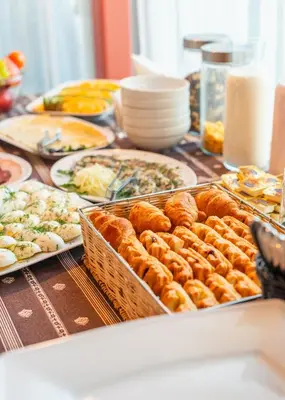 a table with plates of food on top at Hotel Medūna in Druskininkai