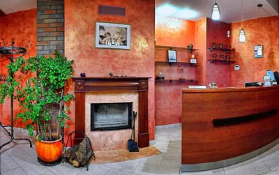 a living room with a fire place and a fireplace at Hotel Medūna in Druskininkai
