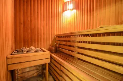 a sauna with a wooden bed and a table at Hotel Zemaites in Vilnius