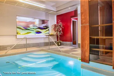 a swimming pool in a room with a painting at Hotel Zemaites in Vilnius