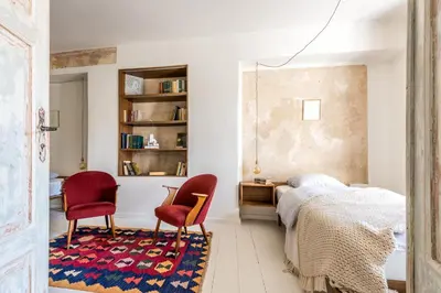 a bedroom with two red chairs and a bed at Angel House Vilnius 29 in Vilnius