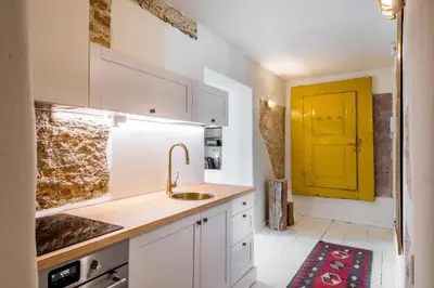 a kitchen with a sink and a yellow door at Angel House Vilnius 29 in Vilnius