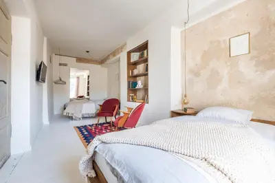 a bedroom with a bed and a table and chairs at Angel House Vilnius 29 in Vilnius