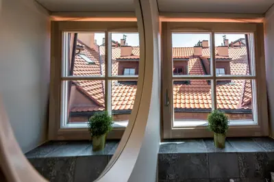 a hallway with two potted plants in front of a window at Angel House Vilnius 40 in Vilnius