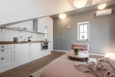 a kitchen and living room with a couch and a table at Angel House Vilnius 40 in Vilnius