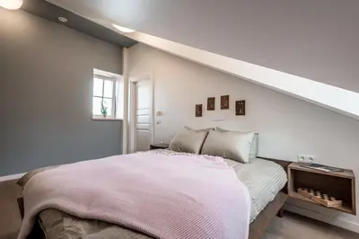 a bedroom with a bed with a pink blanket at Angel House Vilnius 40 in Vilnius