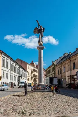 a statue of a woman on a pillar in a city at Angel House Vilnius 38 in Vilnius