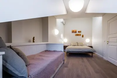 a living room with a couch and a bed at Angel House Vilnius 38 in Vilnius