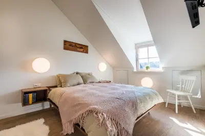 a bedroom with a large bed and a window at Angel House Vilnius 38A in Vilnius