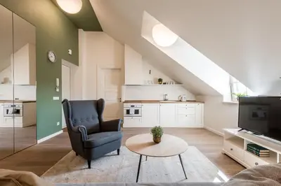 a living room with a chair and a tv at Angel House Vilnius 38A in Vilnius