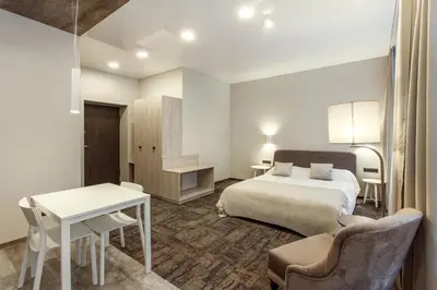 a hotel room with a bed and a desk at Old Town Trio Apartments in Vilnius