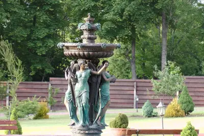 a statue of three women around a fountain at Gazdų Vandens Malūnas in Navininkai
