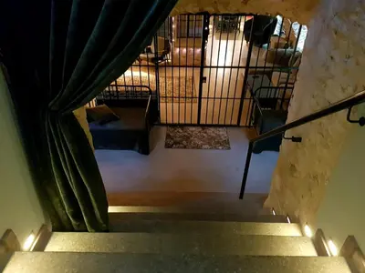 an overhead view of a staircase with green curtains at Unique Old Town Apartment in Vilnius