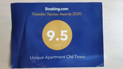 a blue book with a sign that reads traveler review awards at Unique Old Town Apartment in Vilnius