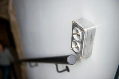 a metal door latch with a flashlight on it at Unique Old Town Apartment in Vilnius