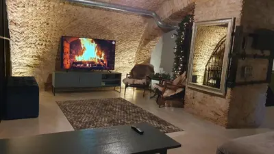 a living room with a tv and a fireplace at Unique Old Town Apartment in Vilnius