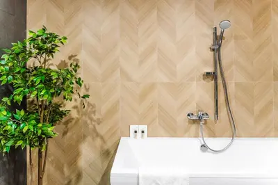 a bathroom with a shower and a white sink at Loop Hotel Vilnius in Vilnius