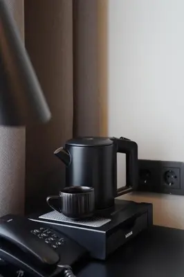 a coffee pot sitting on top of a table at Loop Hotel Vilnius in Vilnius