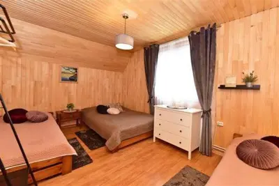 a bedroom with two beds and a window in a room at Sodyba Sauletekis in Ignalina