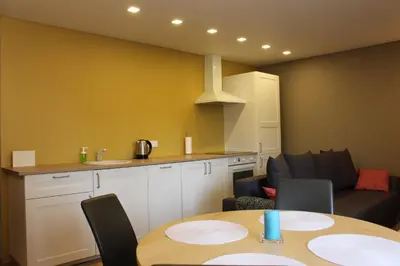 a kitchen and dining room with a table and chairs at Near Park Apartment in Druskininkai