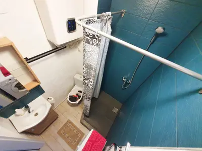 a small bathroom with a shower and a sink at K-Town - City Center Park Studio in Kaunas