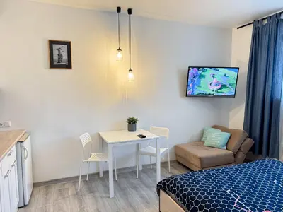 a bedroom with a bed and a table and a couch at K-Town - City Center Park Studio in Kaunas