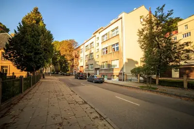 a street with buildings and cars parked on the side of the road at K-Town - City Center Park Studio in Kaunas