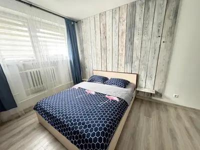 a bedroom with a bed and a window at K-Town - City Center Park Studio in Kaunas