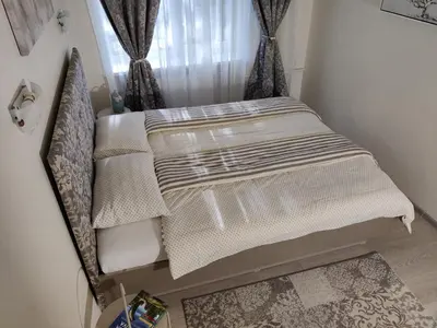 a small bed in a corner of a room at Apartment Dalyce in Šiauliai