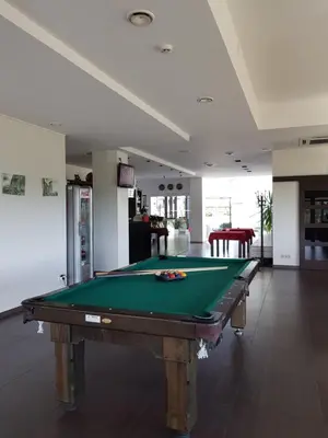 a pool table in the middle of a room at Rezidencija Grįžulo ratai in Sasnava