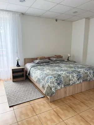a bedroom with a large bed and a window at KAUNO JACHTKLUBAS Baltosios Burės in Kaunas