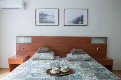 a bedroom with two beds with a tray of tea cups at KAUNO JACHTKLUBAS Baltosios Burės in Kaunas