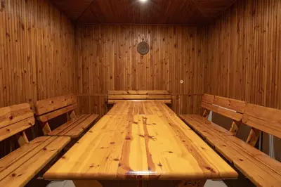 a large wooden table in a room with benches at KAUNO JACHTKLUBAS Baltosios Burės in Kaunas