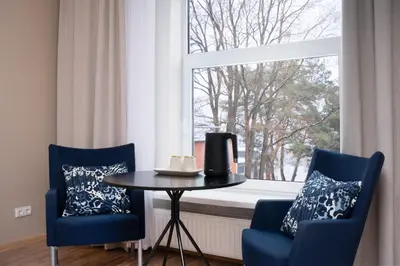 a dining room with a table and two chairs and a window at KAUNO JACHTKLUBAS Baltosios Burės in Kaunas