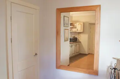 a mirror hanging on a wall next to a kitchen at Mini Home Vilnius Old Town in Vilnius