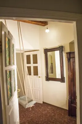 a room with a door and a mirror at Mini Home Vilnius Old Town in Vilnius