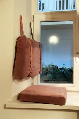 a towel hanging on a wall next to a mirror at Mini Home Vilnius Old Town in Vilnius