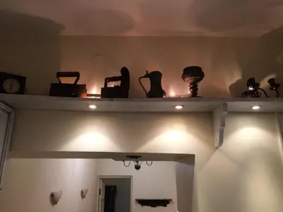 a shelf with items on top of a room at Mini Home Vilnius Old Town in Vilnius