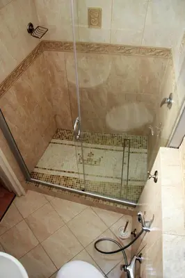 a shower with a glass door in a bathroom at Mini Home Vilnius Old Town in Vilnius
